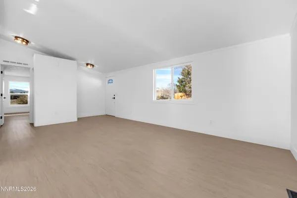 an empty room with windows and closet