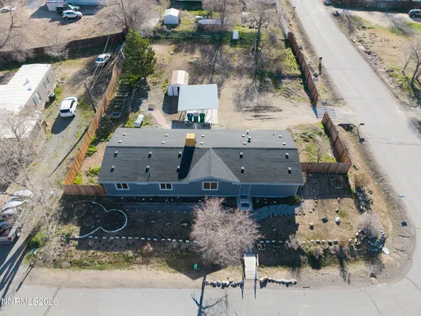 an aerial view of a house with a yard