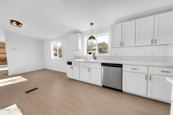 a kitchen with granite countertop white cabinets and white appliances