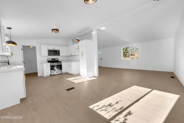 a view of a kitchen with furniture and an empty space