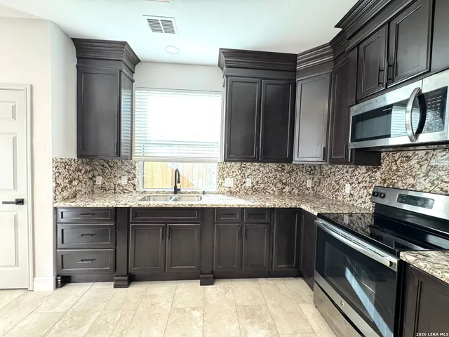 a kitchen with a sink and refrigerator