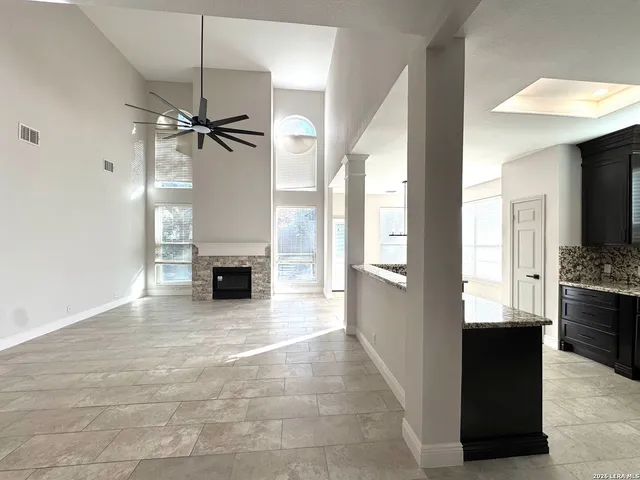 a view of a kitchen with a sink and a fireplace