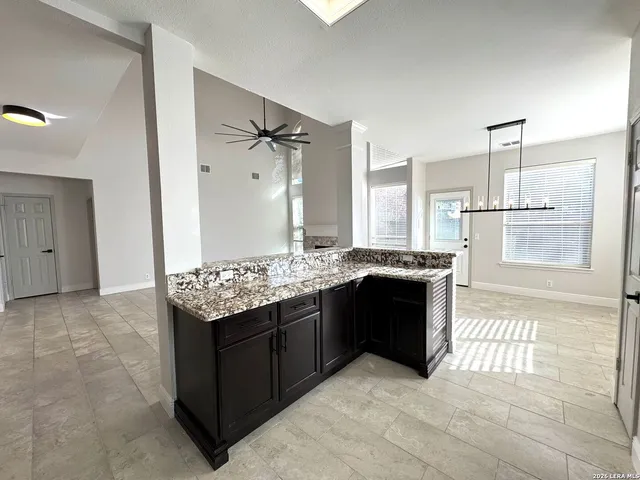 a kitchen with stainless steel appliances granite countertop a sink stove and microwave