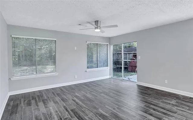 wooden floor in an empty room with a window
