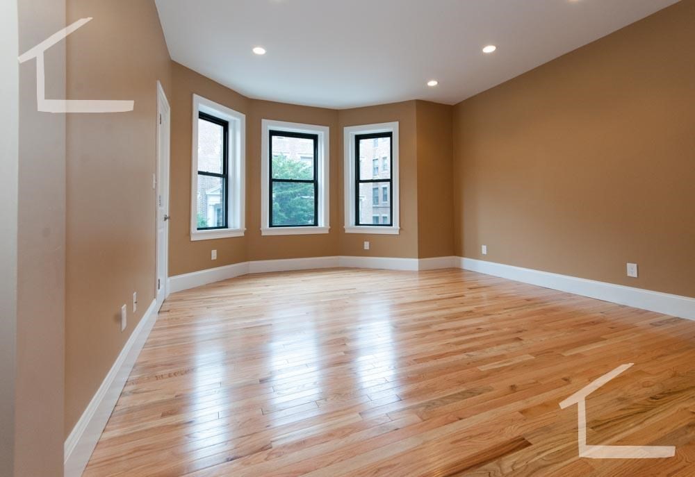 6 Lothian Road, Unit 3 Boston, MA 02135 - Photo 4 of 10 a view of an empty room with wooden floor and a window