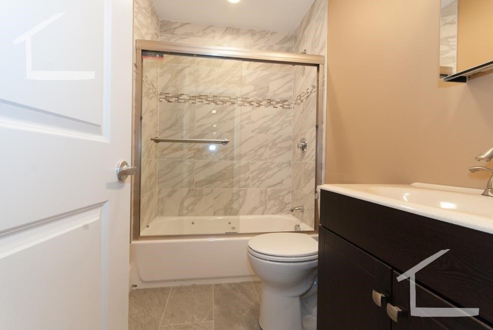 6 Lothian Road, Unit 3 Boston, MA 02135 - Photo 9 of 10 a bathroom with a toilet a sink and shower