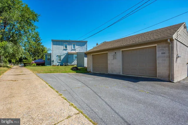 a house view with swimming pool in front of it