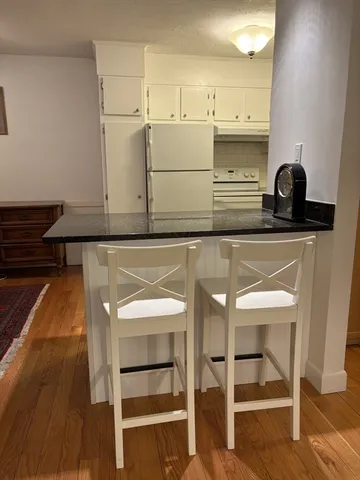a kitchen with cabinets and chairs