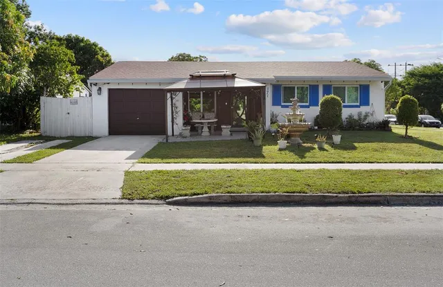 a front view of house with garage and trees