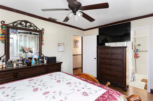 a bed room with a bed a dresser and a mirror