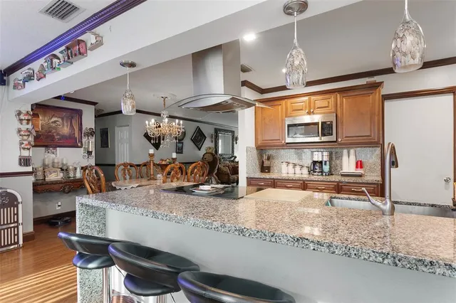 a kitchen with stainless steel appliances granite countertop a sink and a counter space