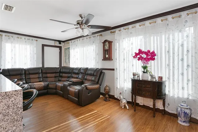 a living room with furniture window and wooden floor
