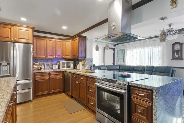 a kitchen with stainless steel appliances granite countertop a sink stove and refrigerator