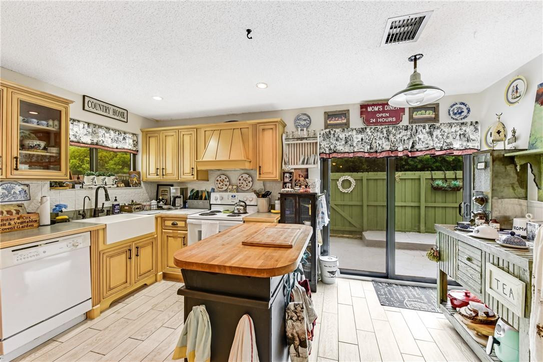 7735 Stanway Place, Unit 7735 Boca Raton, FL 33433 - Photo 13 of 34 a kitchen with a sink a stove and cabinets