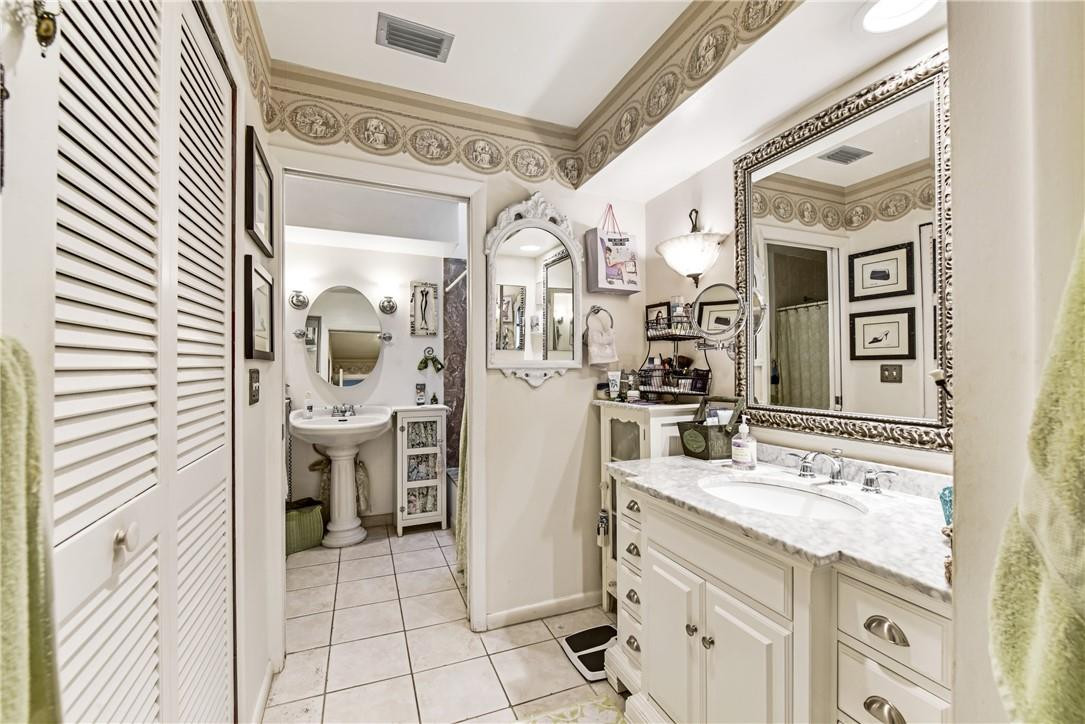 7735 Stanway Place, Unit 7735 Boca Raton, FL 33433 - Photo 19 of 34 a bathroom with a sink a vanity and a mirror