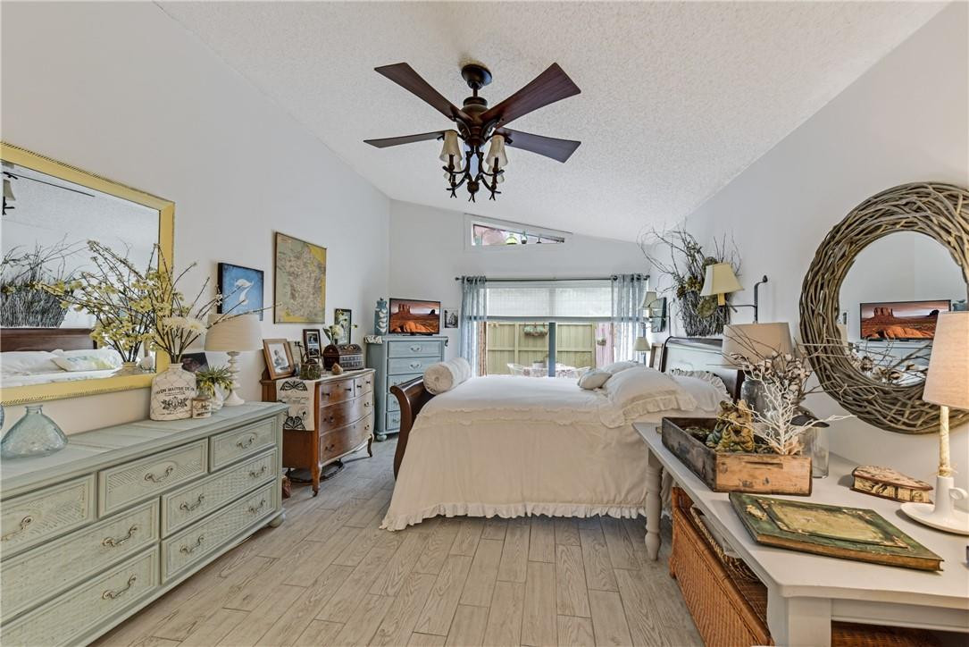 7735 Stanway Place, Unit 7735 Boca Raton, FL 33433 - Photo 20 of 34 a bedroom with a large bed and a chandelier
