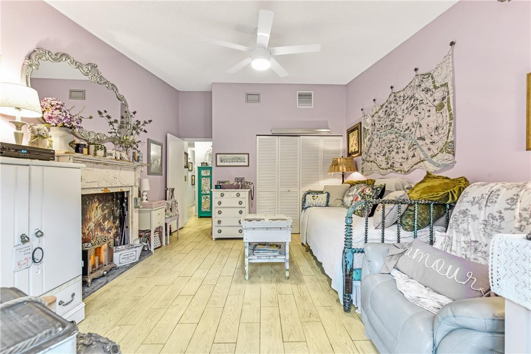 7735 Stanway Place, Unit 7735 Boca Raton, FL 33433 - Photo 22 of 34 a living room with furniture and a fireplace