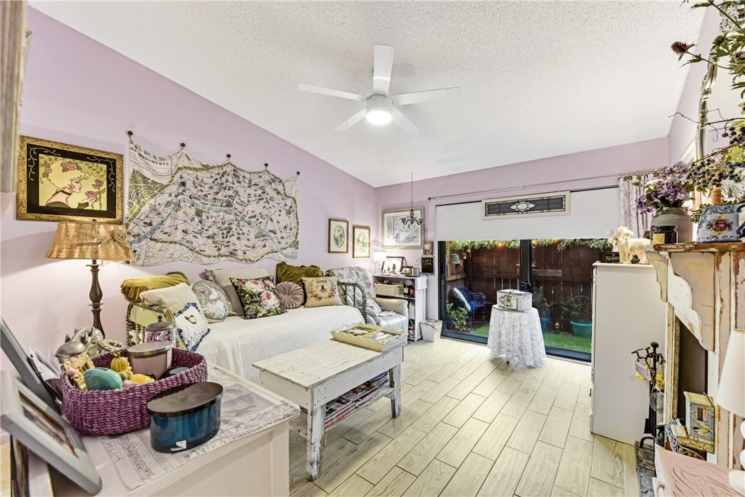 7735 Stanway Place, Unit 7735 Boca Raton, FL 33433 - Photo 23 of 34 a living room with furniture and wooden floor