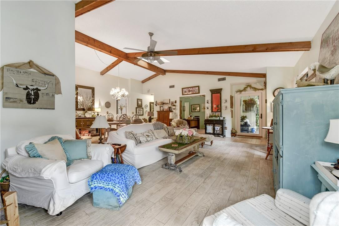 7735 Stanway Place, Unit 7735 Boca Raton, FL 33433 - Photo 27 of 34 a living room with furniture and a chandelier