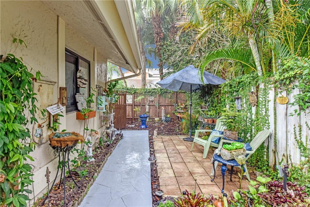 7735 Stanway Place, Unit 7735 Boca Raton, FL 33433 - Photo 3 of 34 a view of a patio with chairs and potted plants
