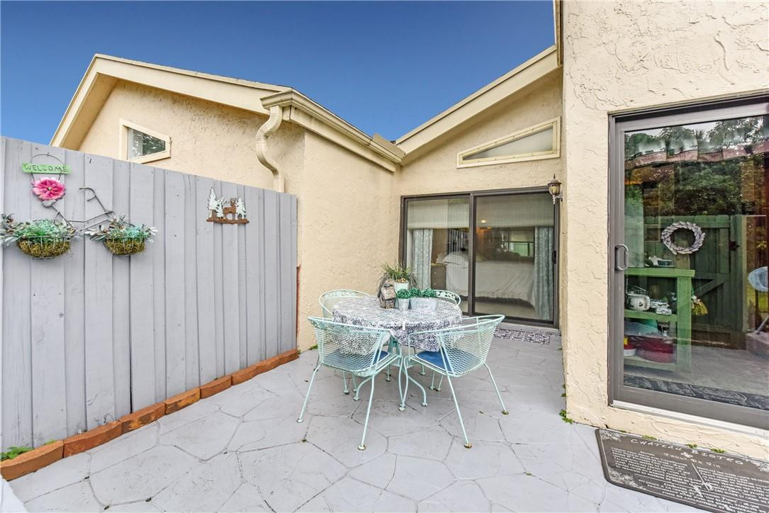 7735 Stanway Place, Unit 7735 Boca Raton, FL 33433 - Photo 7 of 34 a patio with table and chairs