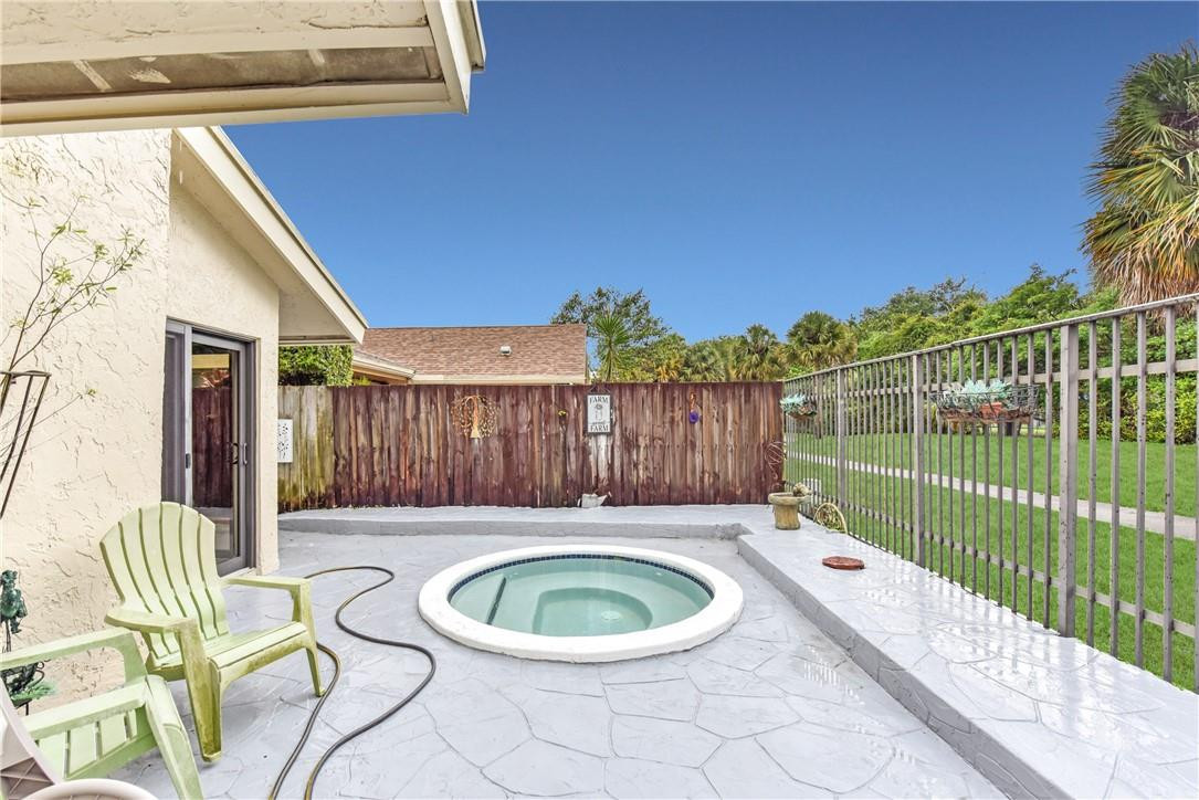 7735 Stanway Place, Unit 7735 Boca Raton, FL 33433 - Photo 9 of 34 a view of a backyard with chair and table