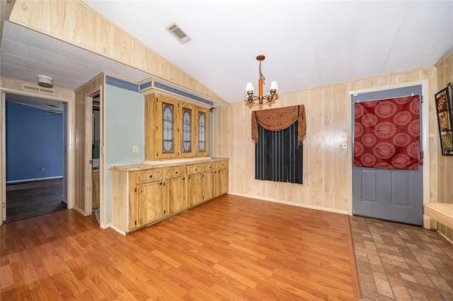 a view of an empty room with a fireplace and a large window
