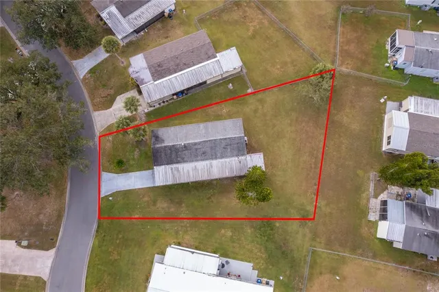 an aerial view of residential house with pool and yard