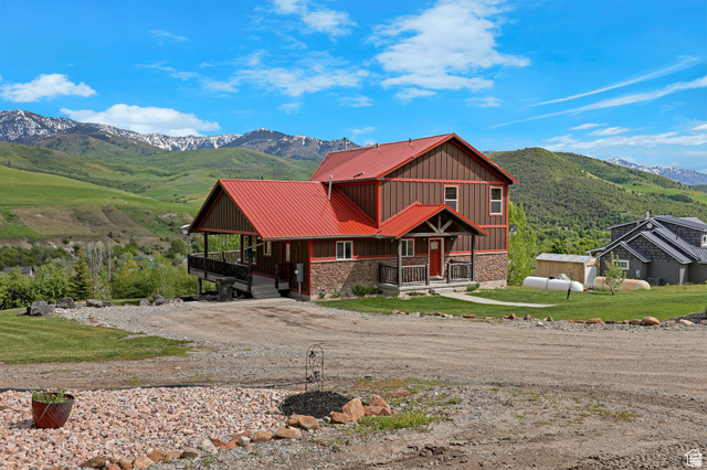 306 Spring Road Preston, ID 83263 - Photo 47 of 55 Two-story exterior with a red metal roof, brown siding, and stone accents