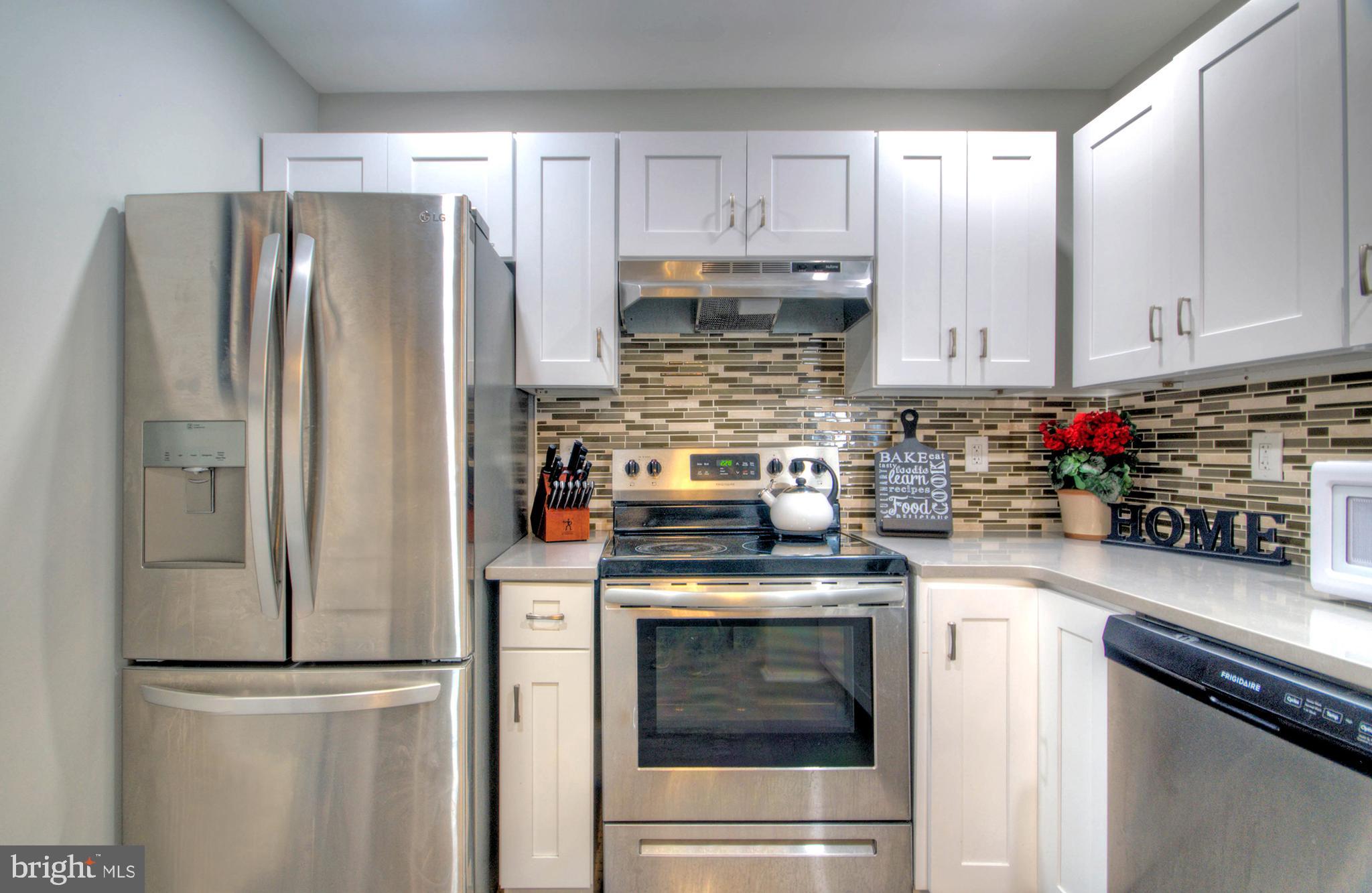 405 Quail Road Marlton, NJ 08053 - Photo 11 of 29 a kitchen with stainless steel appliances granite countertop a refrigerator sink stove and white cabinets
