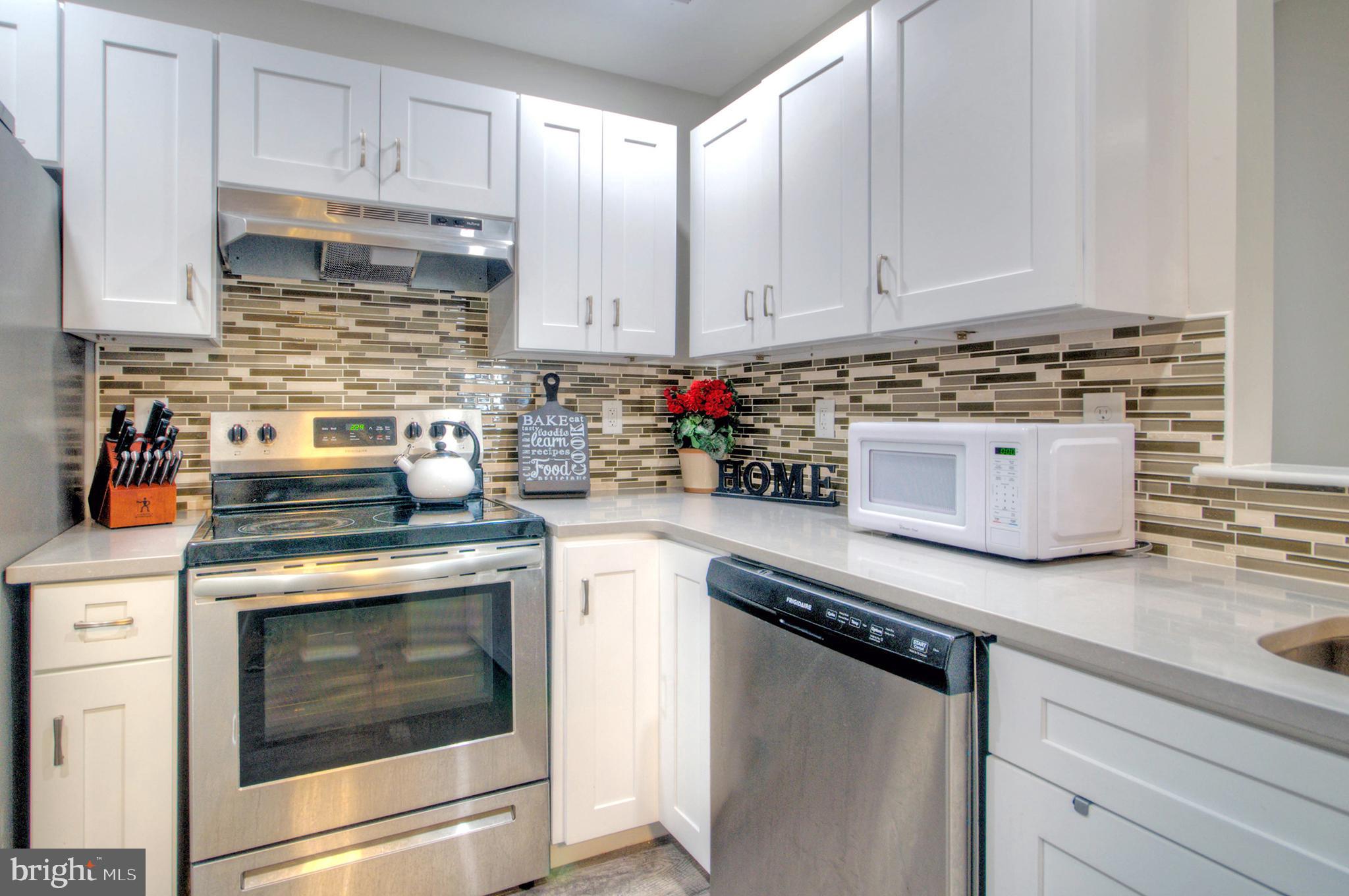 405 Quail Road Marlton, NJ 08053 - Photo 12 of 29 a kitchen with stainless steel appliances granite countertop a stove sink and cabinets