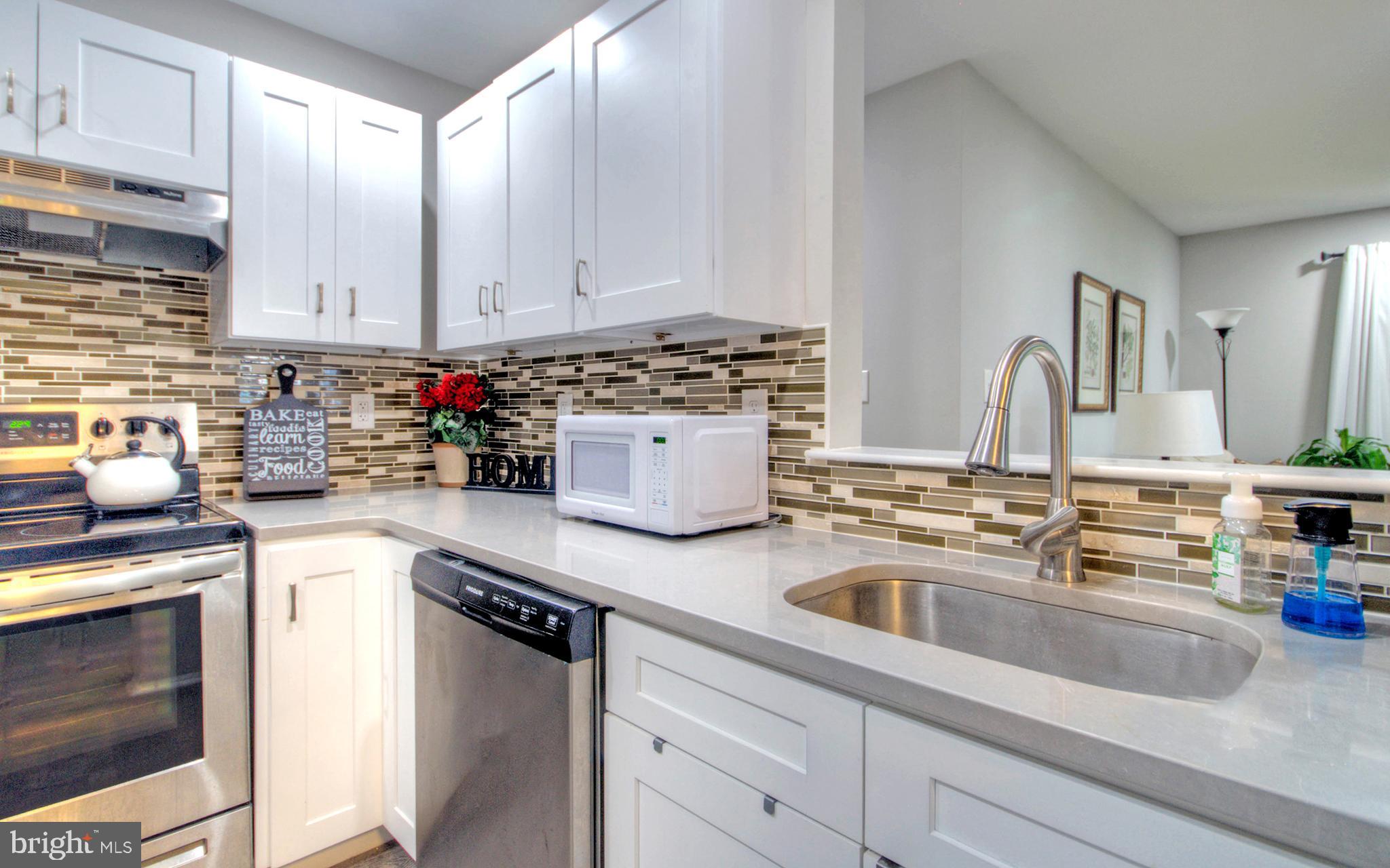 405 Quail Road Marlton, NJ 08053 - Photo 13 of 29 a kitchen with stainless steel appliances granite countertop a sink stove and cabinets