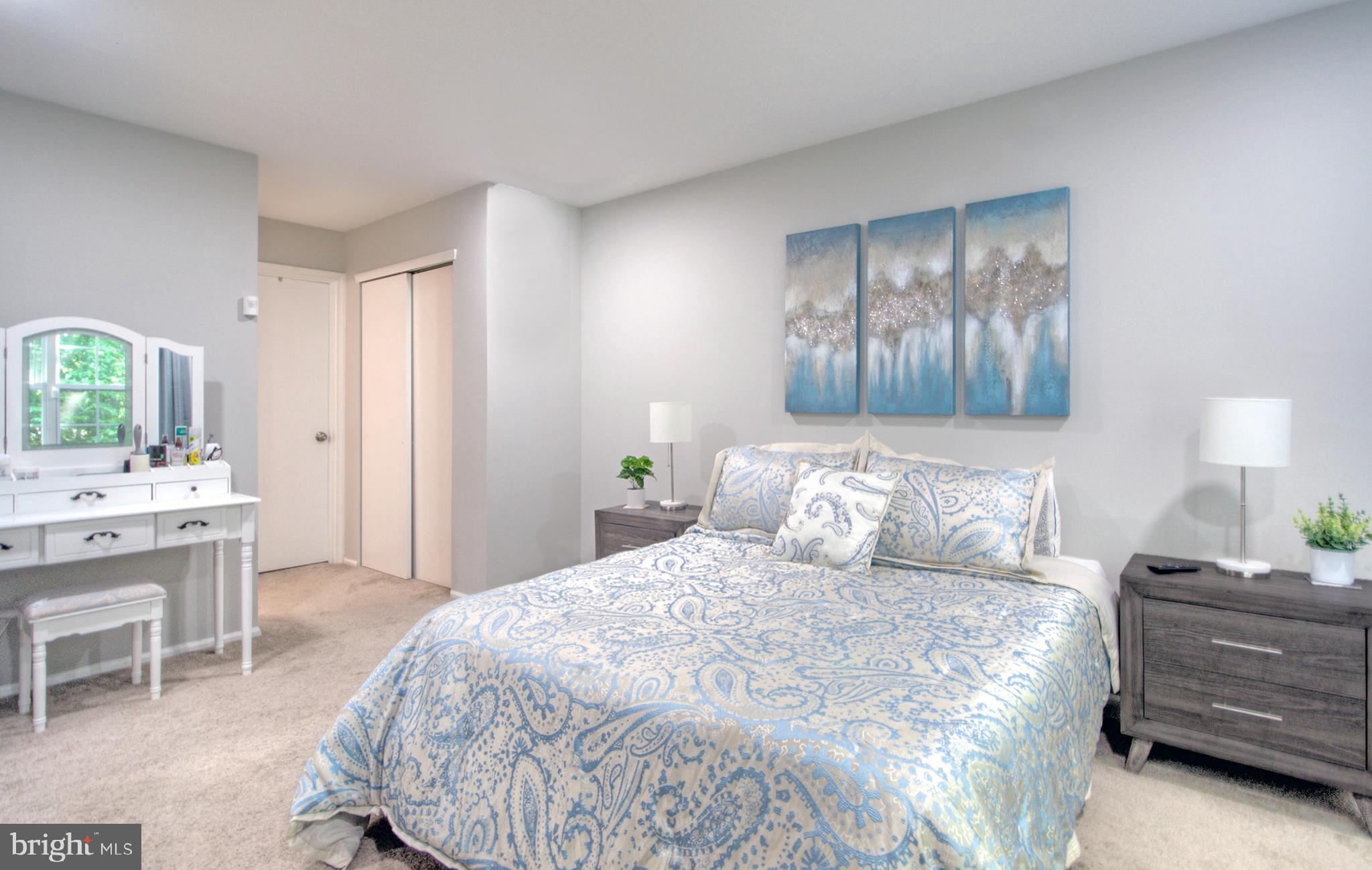 405 Quail Road Marlton, NJ 08053 - Photo 25 of 29 a bedroom with a bed and a chandelier