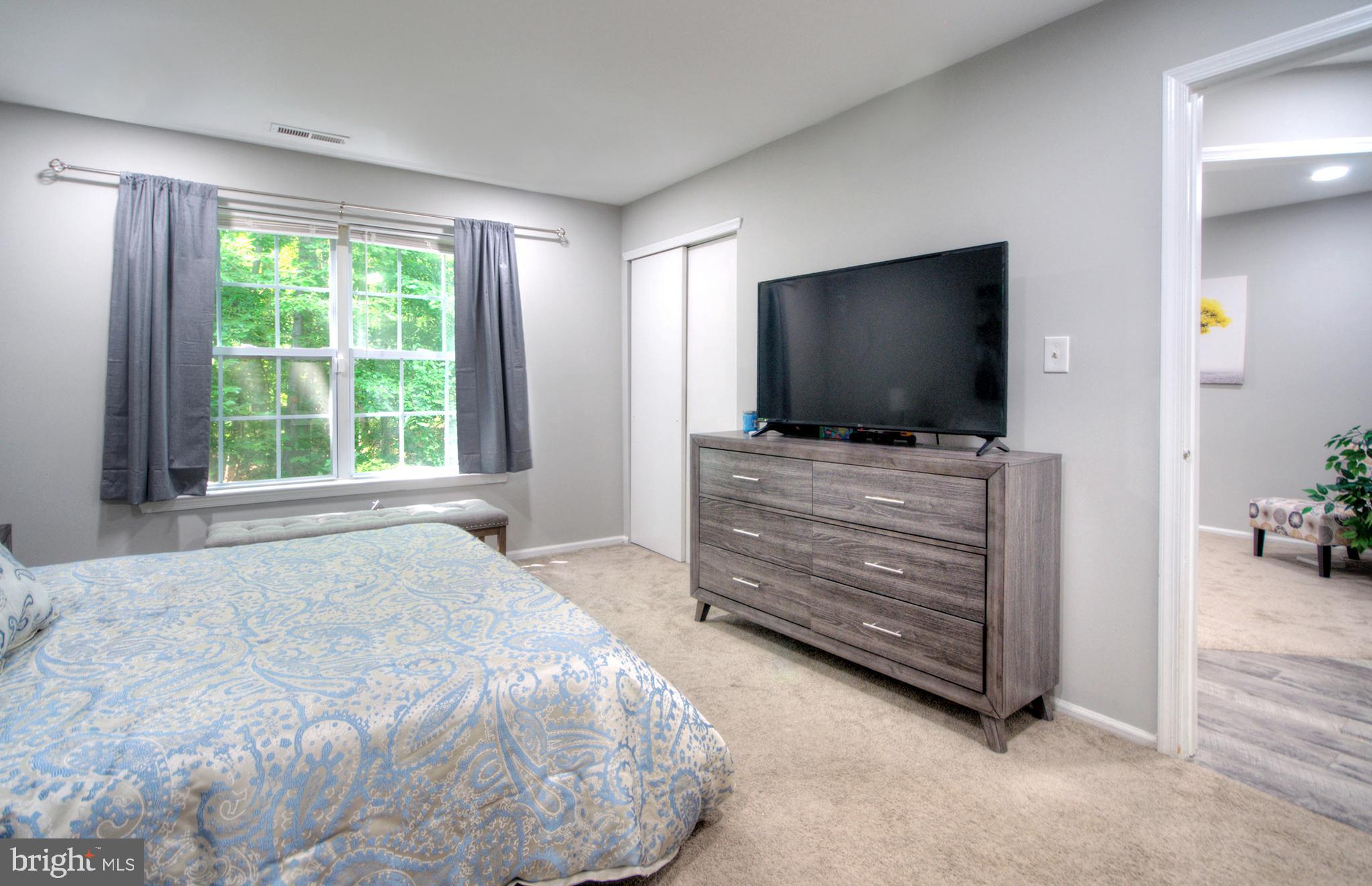 405 Quail Road Marlton, NJ 08053 - Photo 26 of 29 a bedroom with a bed and flat screen tv