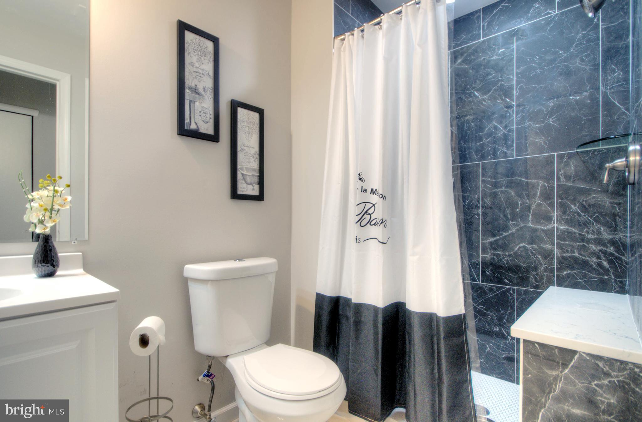 405 Quail Road Marlton, NJ 08053 - Photo 27 of 29 a white toilet sitting next to a bathroom sink