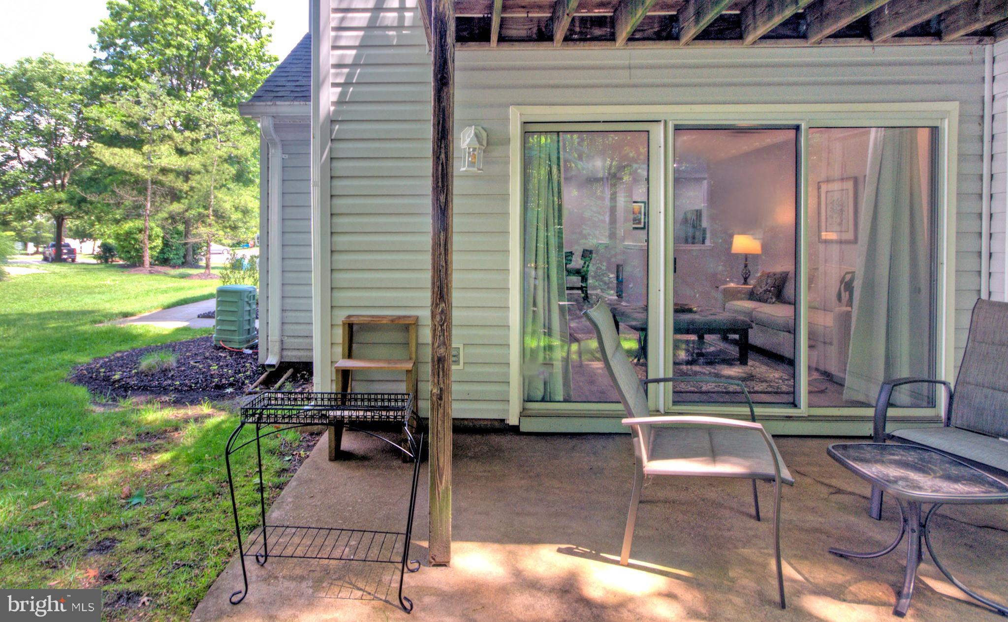 405 Quail Road Marlton, NJ 08053 - Photo 4 of 29 a view of a patio with table and chairs potted plants and a large tree