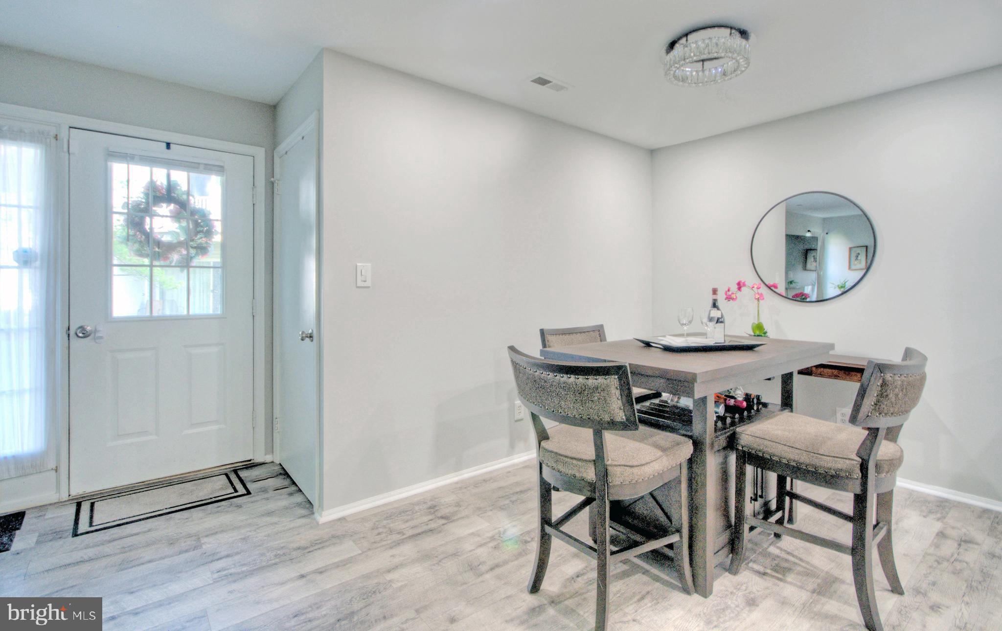 405 Quail Road Marlton, NJ 08053 - Photo 9 of 29 a view of a dining room and livingroom with furniture window and wooden floor