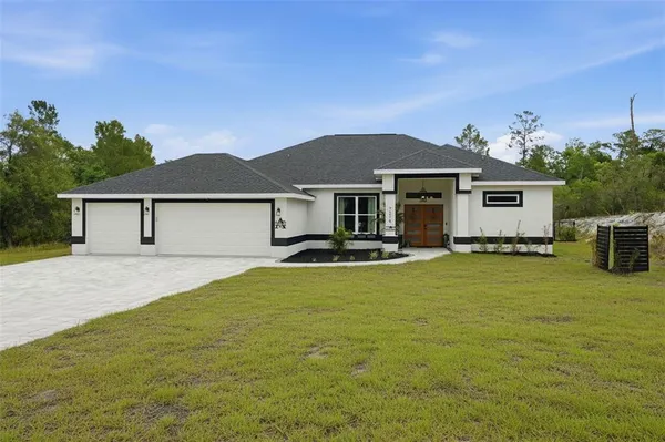 a front view of a house with yard