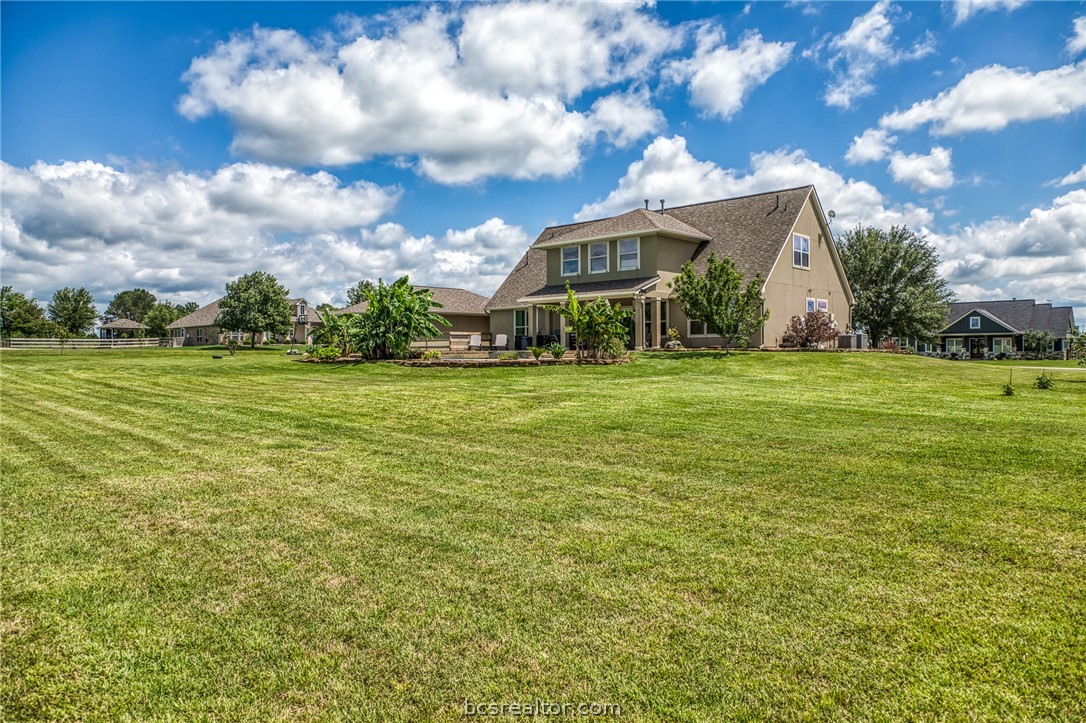 586 Ruby Drive Bellville, TX 77418 - Photo 39 of 50 a view of a big house with a big yard and large trees