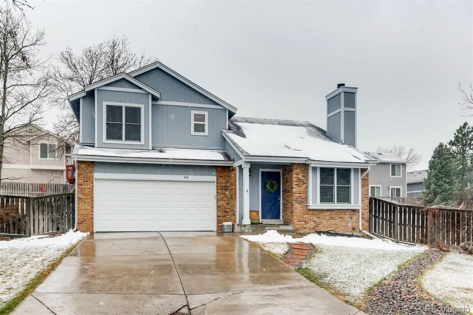 696 Myrtlewood Court Highlands Ranch, CO 80126 - Photo 1 of 12 a front view of a house with a garage