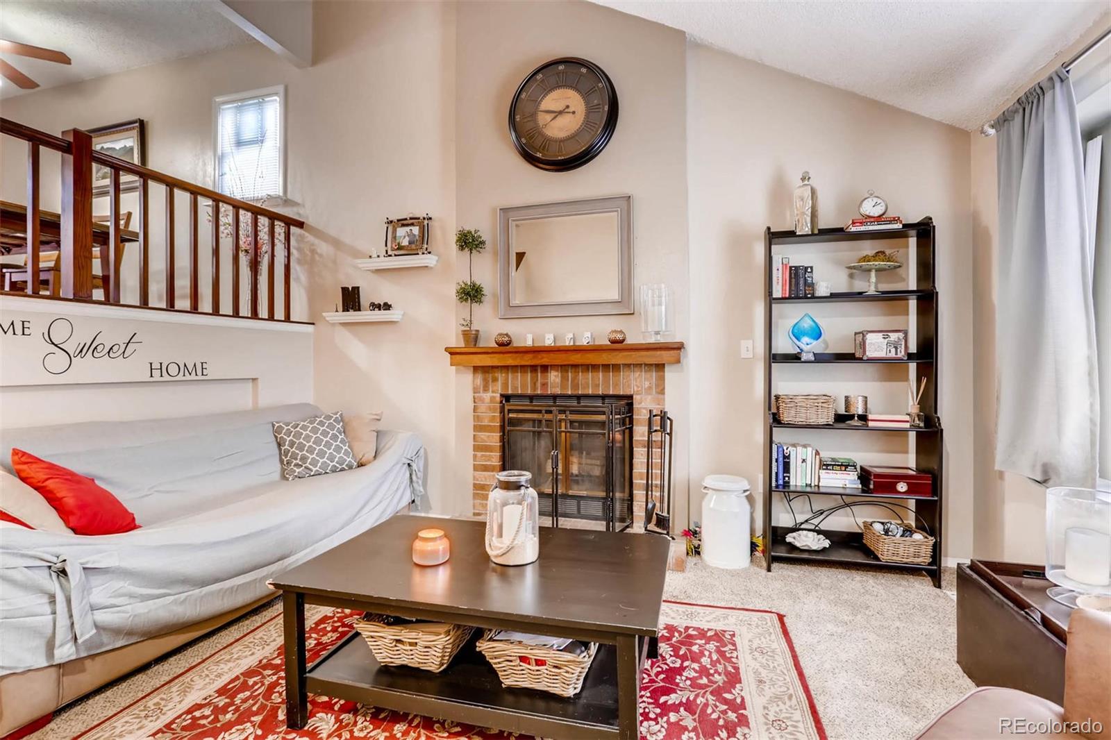 696 Myrtlewood Court Highlands Ranch, CO 80126 - Photo 2 of 12 a living room with furniture and a fireplace