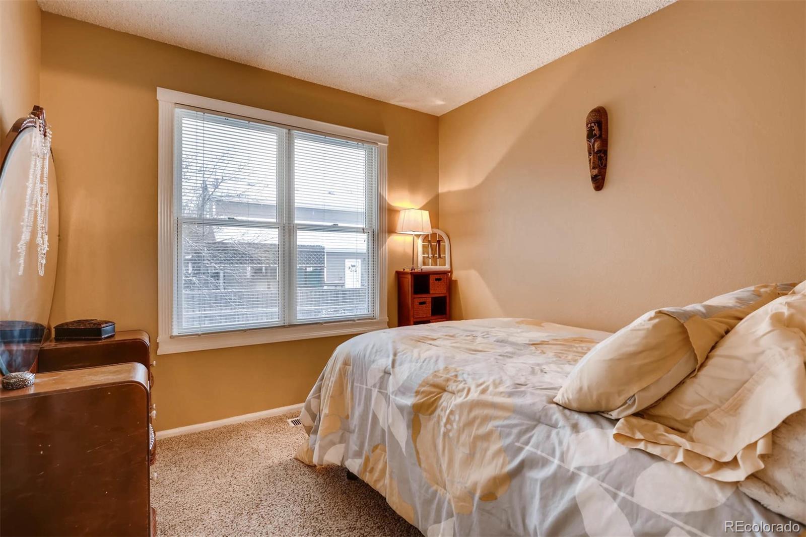696 Myrtlewood Court Highlands Ranch, CO 80126 - Photo 9 of 12 a bedroom with a bed and window