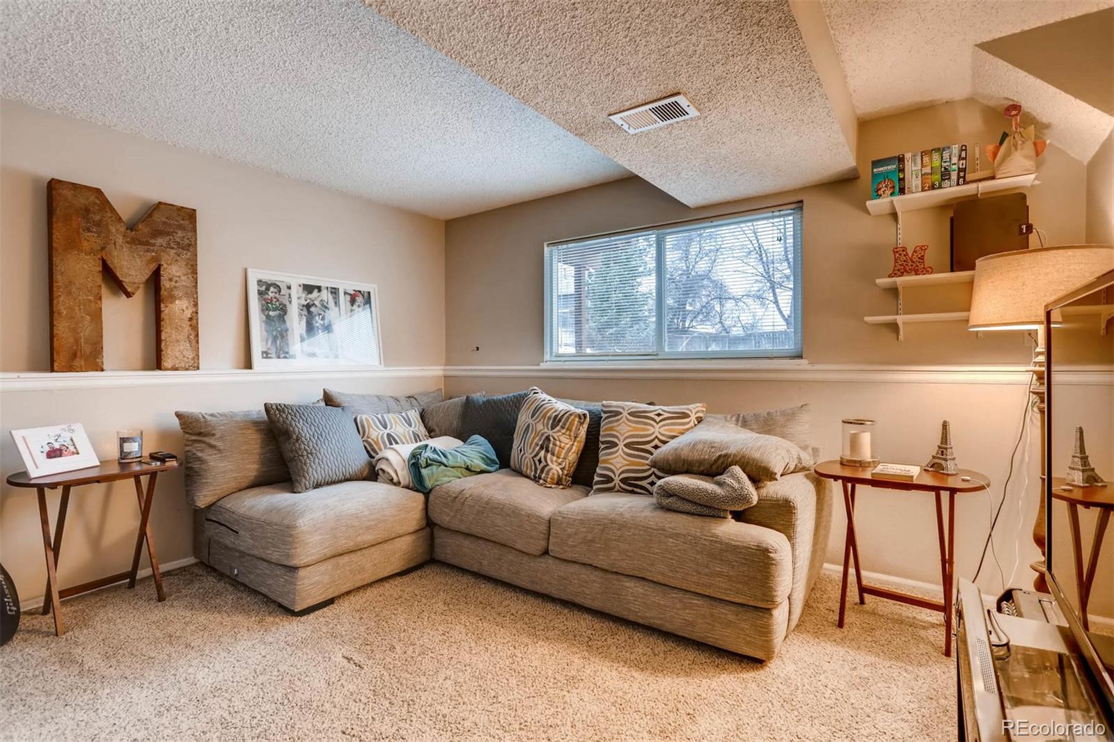 696 Myrtlewood Court Highlands Ranch, CO 80126 - Photo 10 of 12 a living room with furniture and a large window
