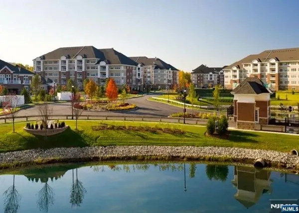 a sign of golf club on a wall under a tree