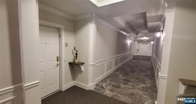 a kitchen with stainless steel appliances granite countertop sink refrigerator and wooden floor