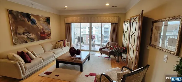 a view of a dining room with furniture and a chandelier