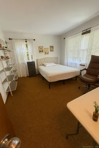 a bedroom with a bed and window