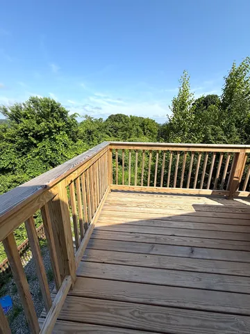 a balcony with wooden floor and fence