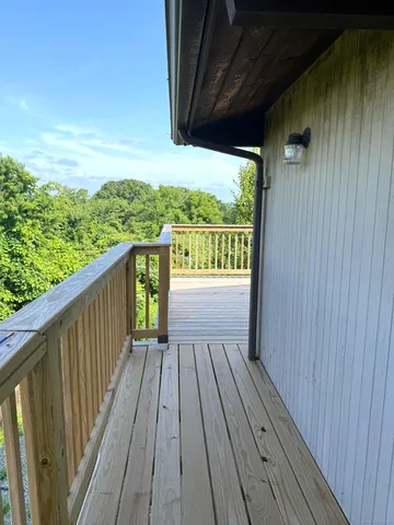 a view of balcony with wooden floor