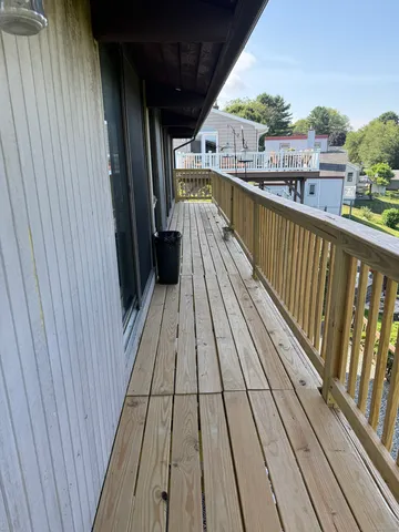 a view of balcony with wooden floor